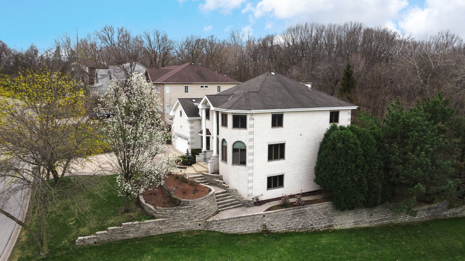 441 Delaware Circle Bolingbrook, IL 60440 - Photo 8 of 69 a view of a white house next to a yard with big trees
