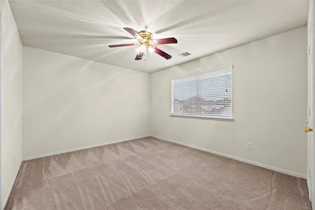 a spacious bathroom with a shower a sink and a mirror