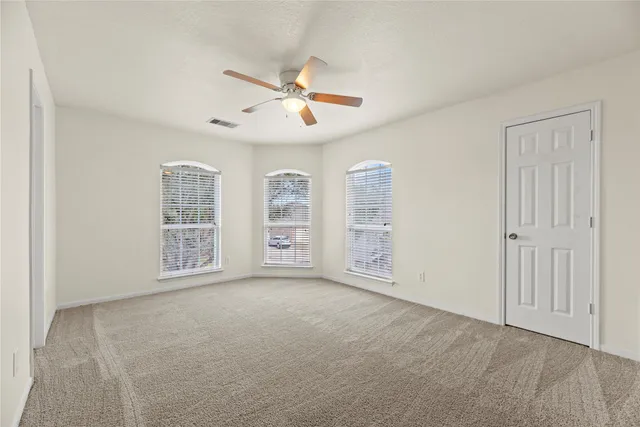 a view of room with a ceiling fan and window