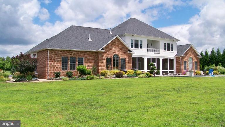 3411 Soper Road Huntingtown, MD 20639 - Photo 14 of 28 a front view of a house with a garden and porch