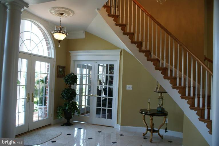 3411 Soper Road Huntingtown, MD 20639 - Photo 19 of 28 a view of staircase with railing and a chandelier