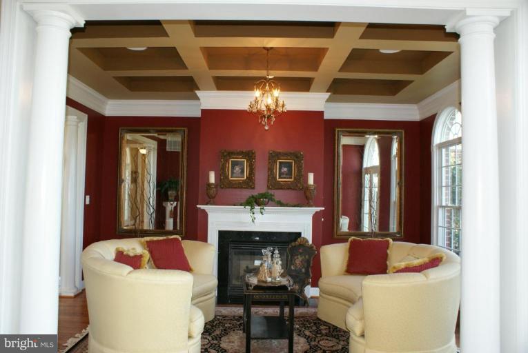 3411 Soper Road Huntingtown, MD 20639 - Photo 20 of 28 a living room with furniture a fireplace and a chandelier