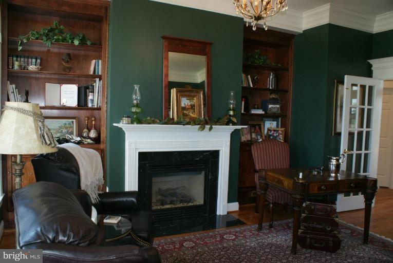 3411 Soper Road Huntingtown, MD 20639 - Photo 21 of 28 a living room with furniture and a fireplace