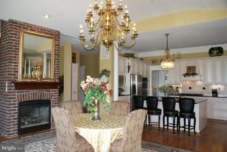 3411 Soper Road Huntingtown, MD 20639 - Photo 22 of 28 a dining room with furniture a chandelier and wooden floor