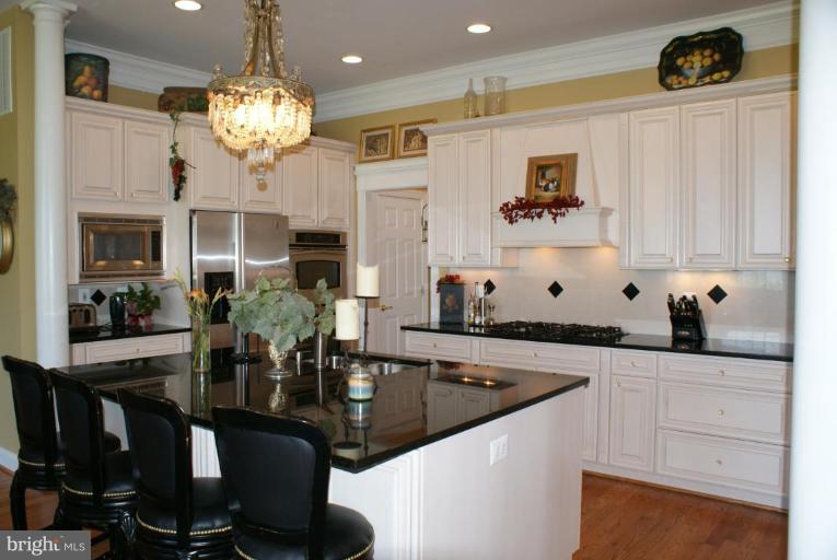 3411 Soper Road Huntingtown, MD 20639 - Photo 23 of 28 a kitchen with stainless steel appliances granite countertop a sink and cabinets