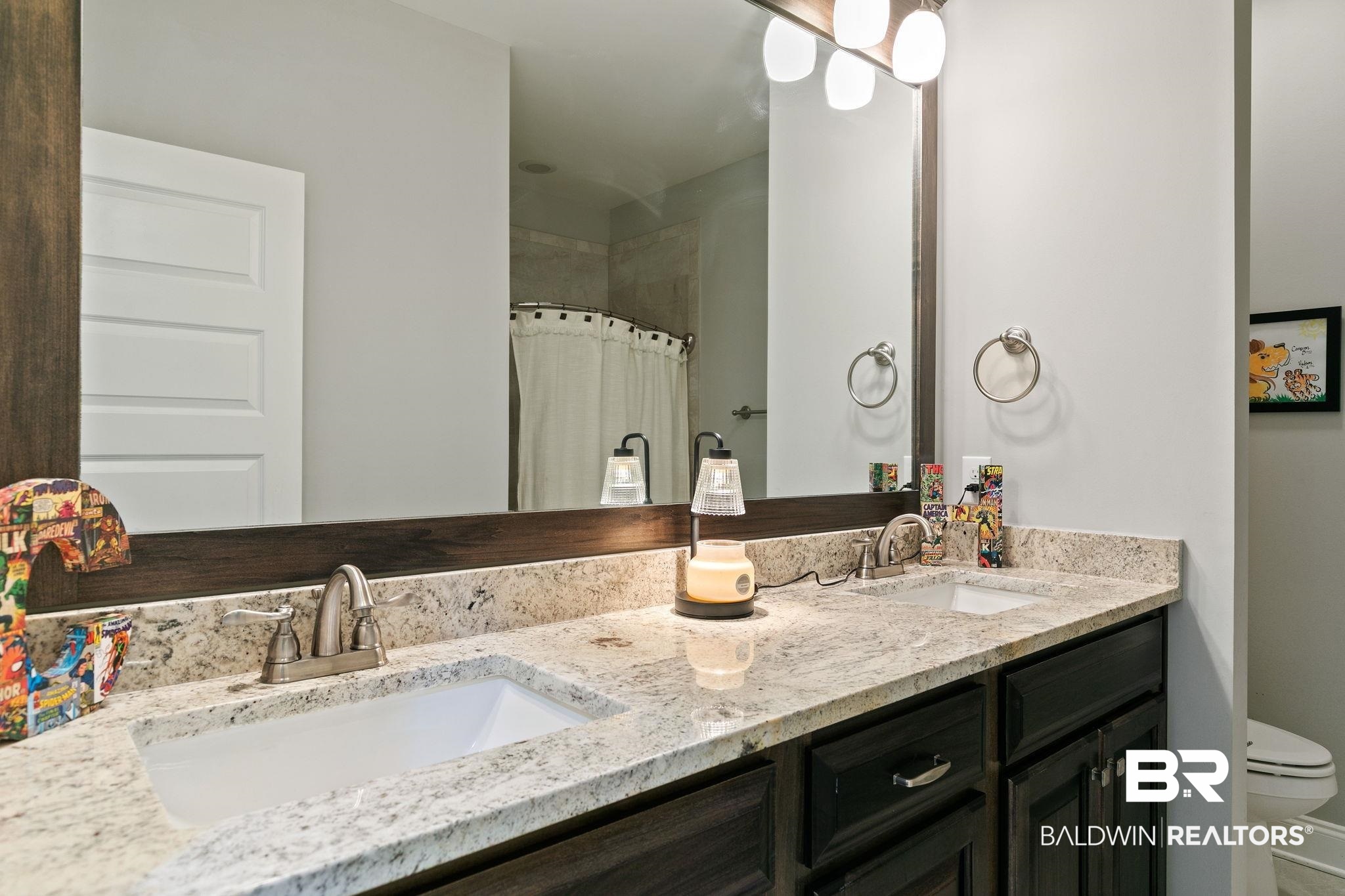 31911 Bobwhite Road Daphne, AL 36527 - Photo 41 of 85 Bathroom featuring double vanity and a shower with shower curtain