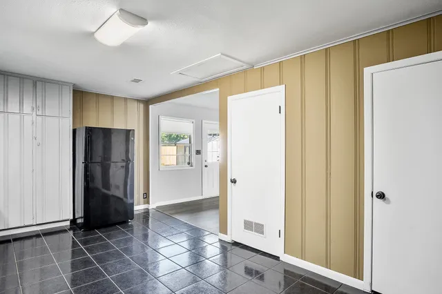 a view of a hallway with wooden shelves