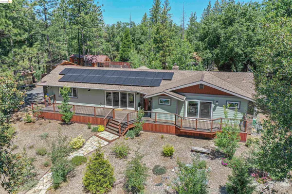 an aerial view of a house with a yard