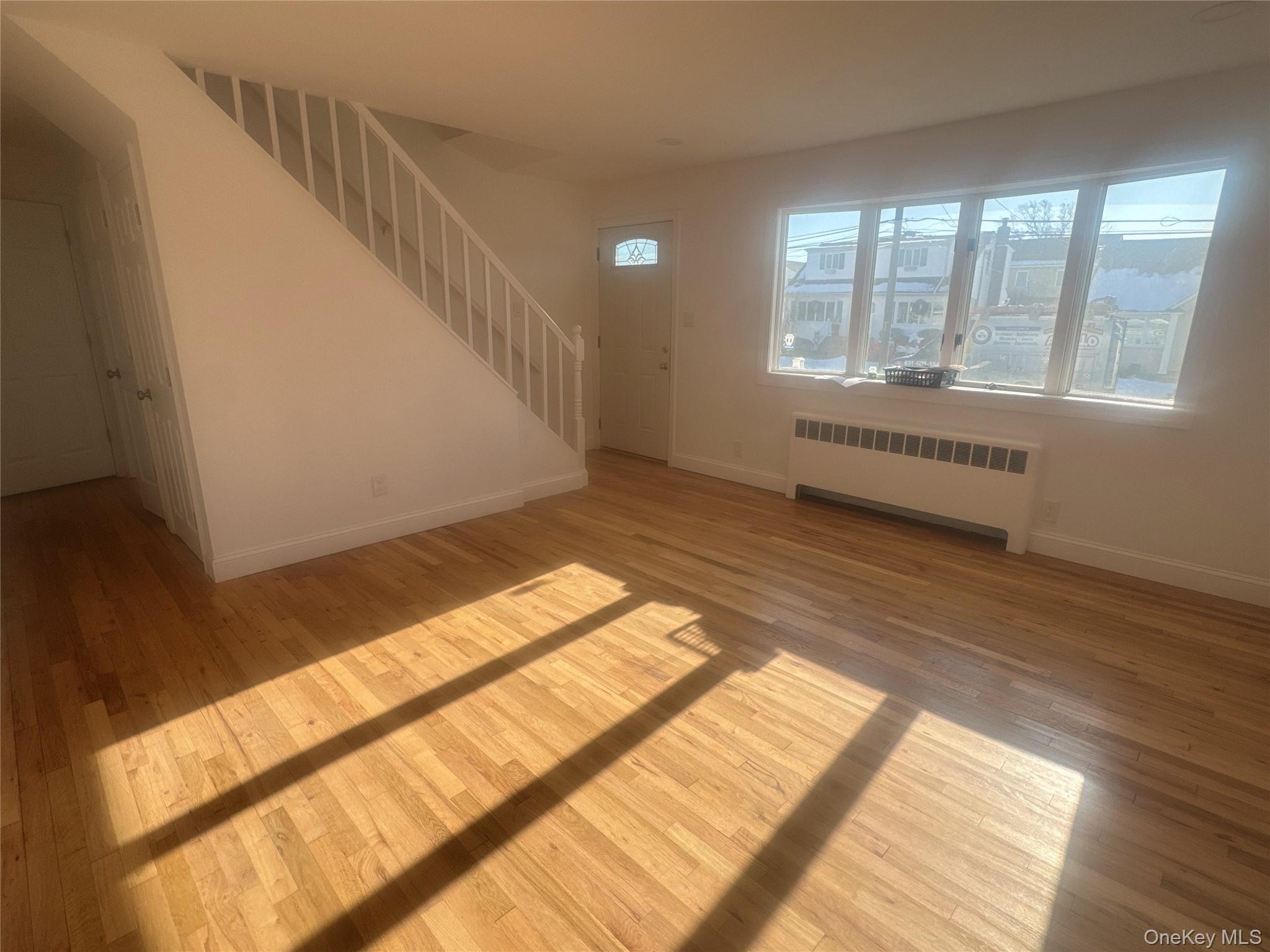 a view of an empty room and wooden floor