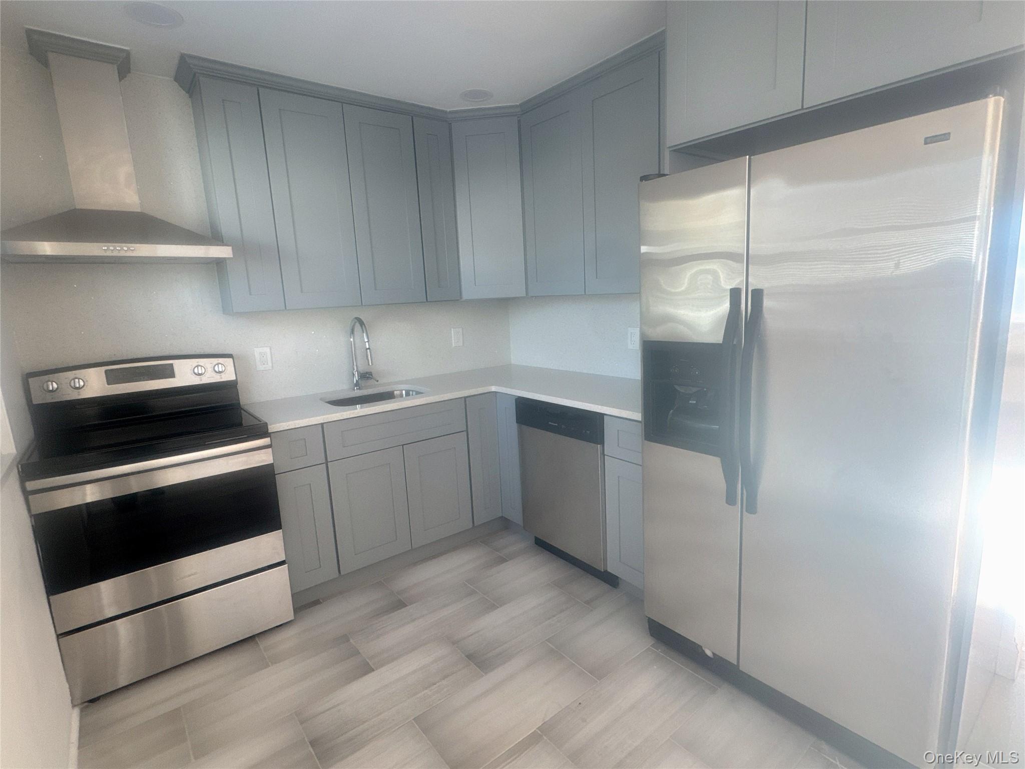 2573 Legion Street Bellmore, NY 11710 - Photo 5 of 13 a kitchen with a sink and white cabinets