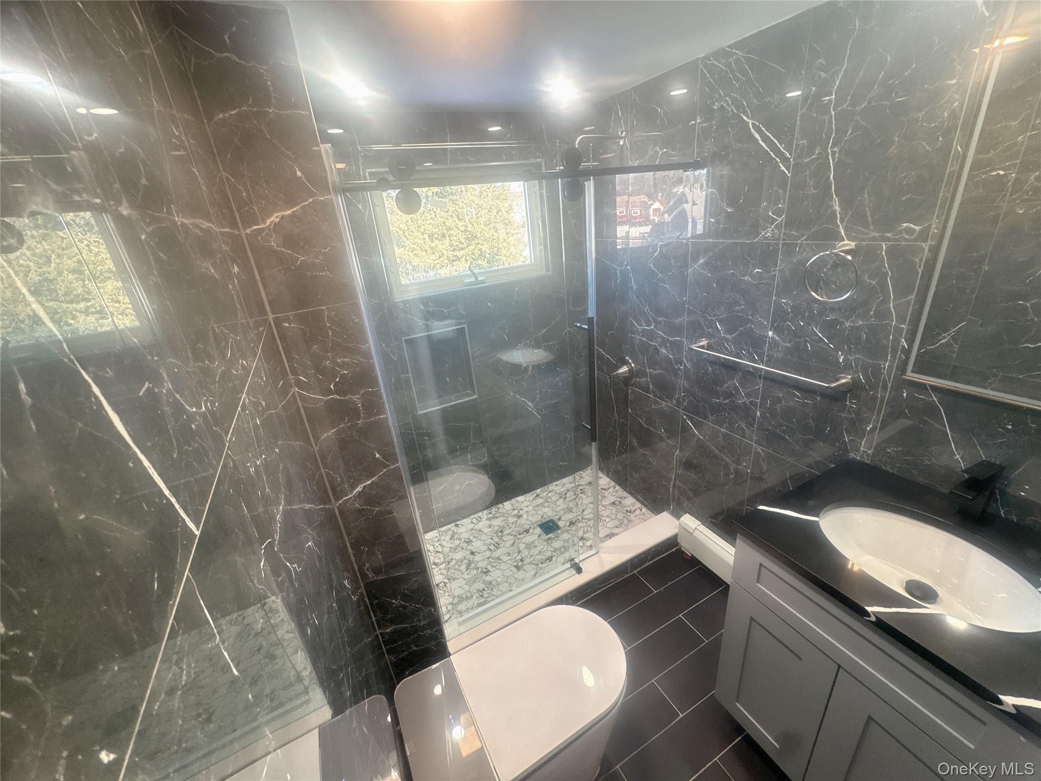 2573 Legion Street Bellmore, NY 11710 - Photo 9 of 13 a bathroom with a sink and mirror