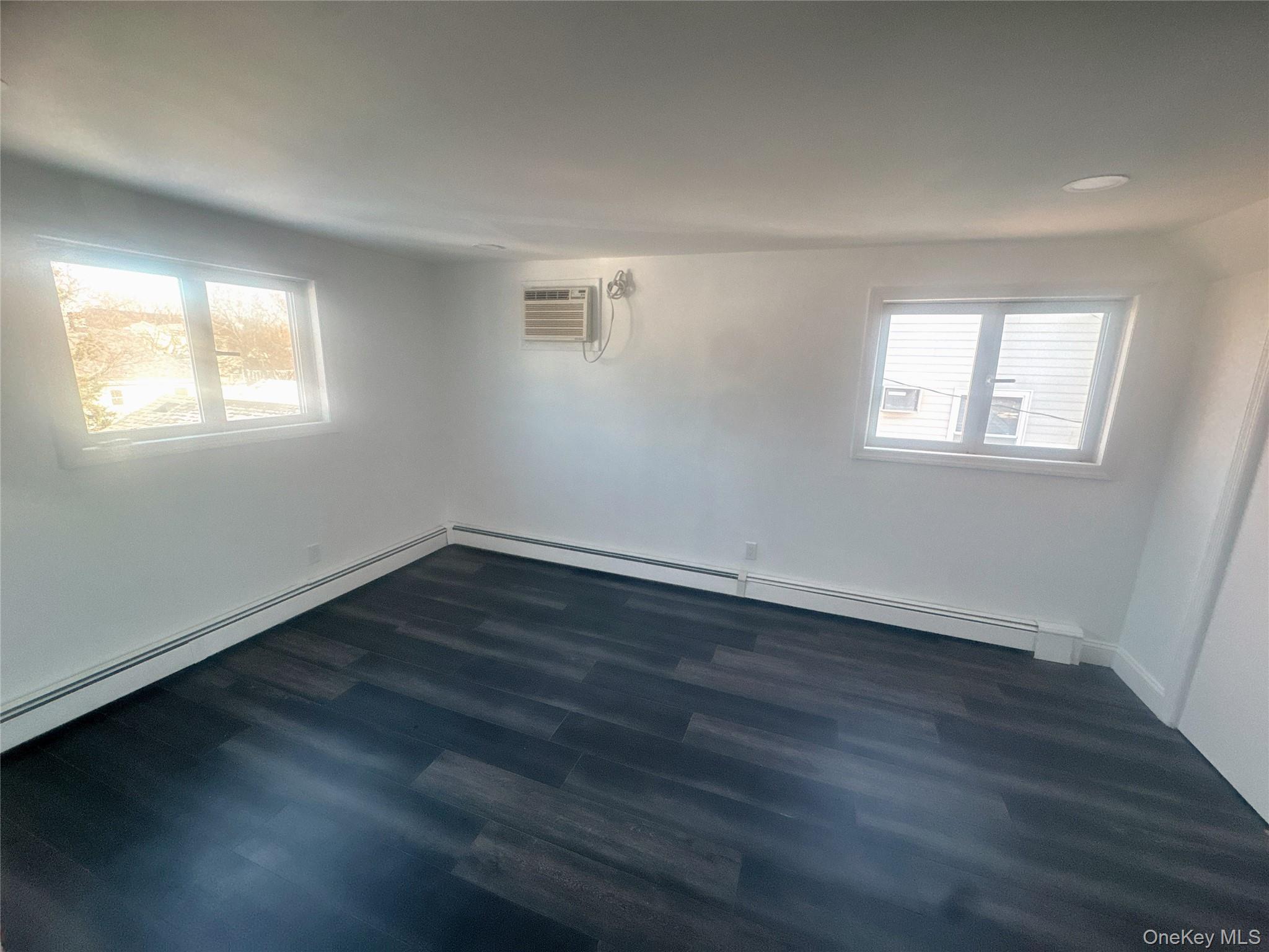 2573 Legion Street Bellmore, NY 11710 - Photo 10 of 13 a view of an empty room with wooden floor and a window