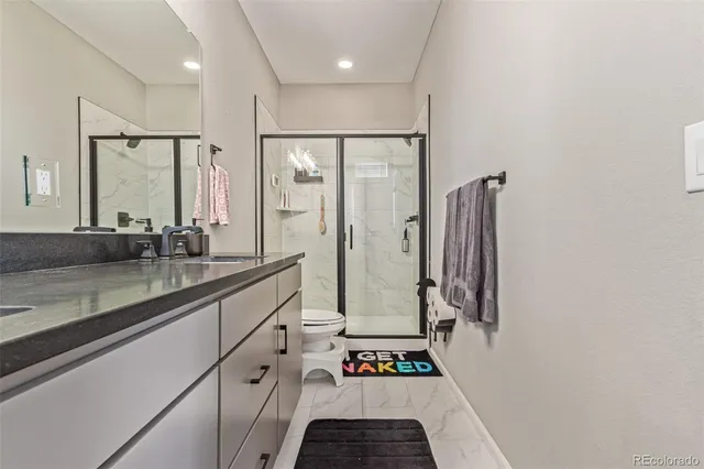 a bathroom with a double vanity sink and a large mirror