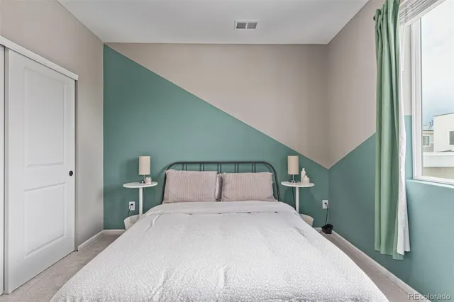 a bedroom with a large bed and a window