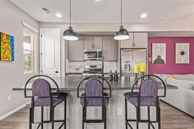 a view of a dining room with furniture wooden floor and chandelier
