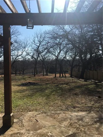 a view of a yard with a tree