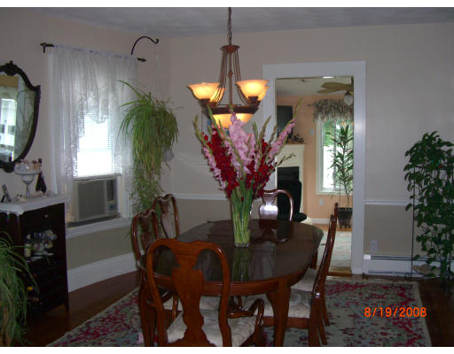 6 Middlesex Avenue Reading, MA 01867 - Photo 2 of 9 a view of a dining room with furniture and a potted plant