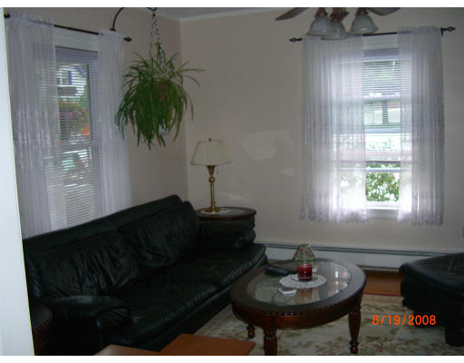 6 Middlesex Avenue Reading, MA 01867 - Photo 8 of 9 a living room with furniture and a potted plant