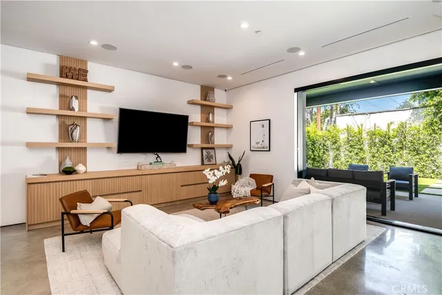 a dining room kitchen with stainless steel appliances granite countertop a stove a sink a refrigerator dining table and chairs