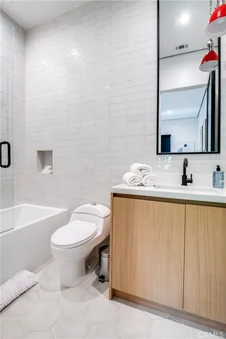 a bedroom with a bed window and a flat screen tv