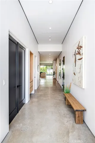a hallway with a view of living room with furniture