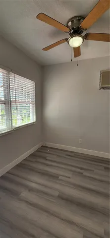 a view of a room with a window and a ceiling fan