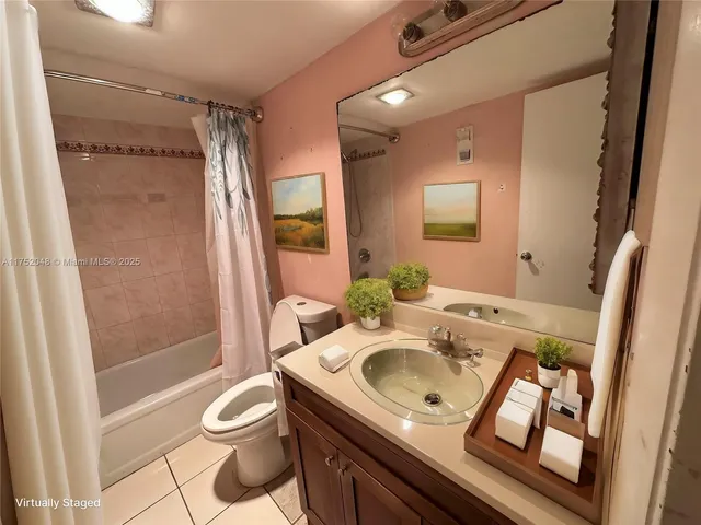 a bathroom with a sink a toilet a mirror and shower