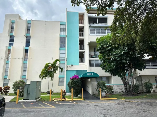 a front view of a building with small garden