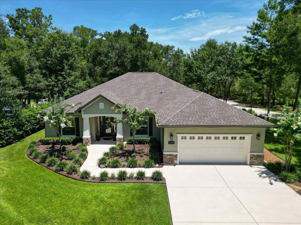 4359 Southwest 117th Place Ocala, FL 34476 - Photo 2 of 58 a aerial view of a house with a yard table and chairs