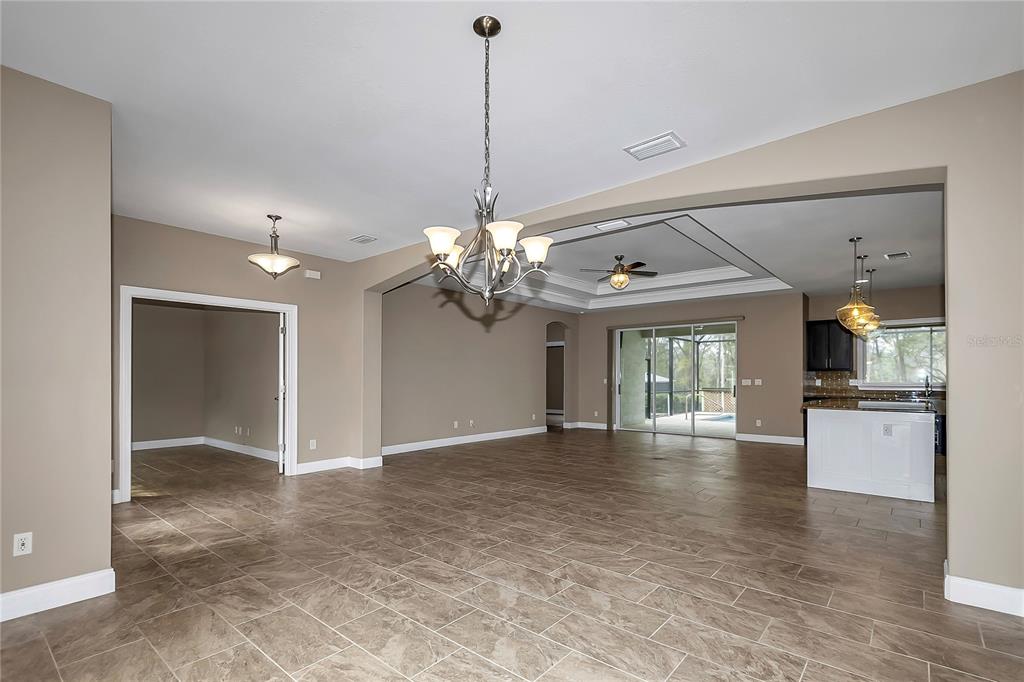 4359 Southwest 117th Place Ocala, FL 34476 - Photo 8 of 58 a view of a room with chandelier and kitchen view