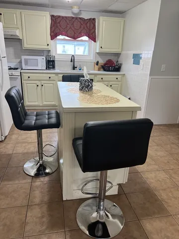 a view of kitchen and dining room with furniture and wooden floor