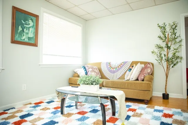 a living room with furniture and flowers