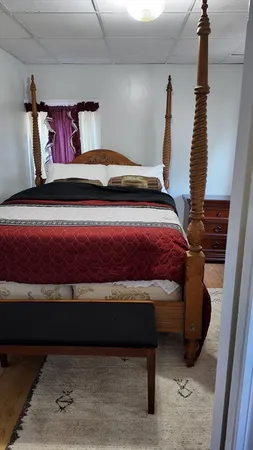 a bedroom with a bed and window