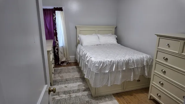 a bedroom with a bed and a mirror