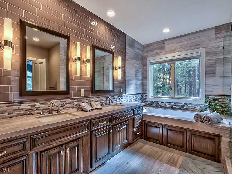 818 Ophir Peak Road Incline Village, NV 89451 - Photo 14 of 31 a large kitchen with kitchen island granite countertop a sink and wooden cabinets
