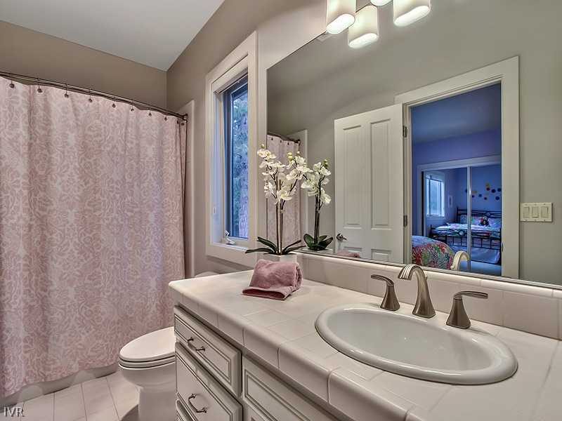 818 Ophir Peak Road Incline Village, NV 89451 - Photo 18 of 31 a bathroom with a granite countertop sink a toilet and a mirror