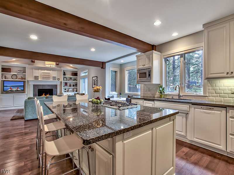 818 Ophir Peak Road Incline Village, NV 89451 - Photo 7 of 31 a kitchen with stainless steel appliances granite countertop a stove a sink a microwave a dining table and chairs