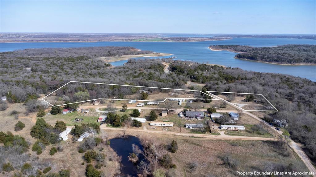 Aerial overview of property's location featuring a nearby body of water and property boundaries highlighted