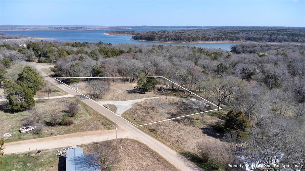 4185 Rock Creek Road Whitesboro, TX 76273 - Photo 11 of 18 Aerial view of property and surrounding area featuring a large body of water and property parcel outlined