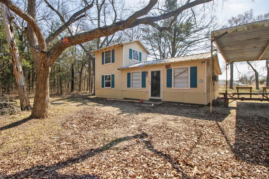 4185 Rock Creek Road Whitesboro, TX 76273 - Photo 15 of 18 Back of property featuring a metal roof