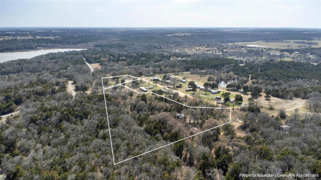 4185 Rock Creek Road Whitesboro, TX 76273 - Photo 3 of 18 Aerial view of property's location featuring a forest and property parcel outlined