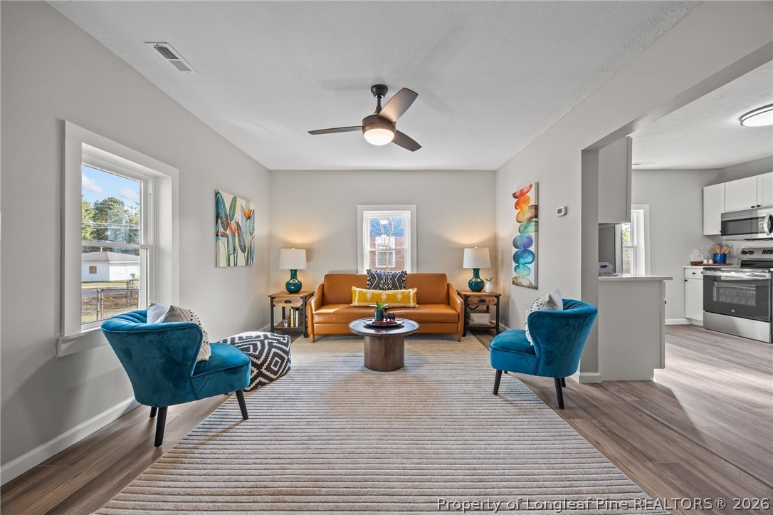 625 Eva Circle Spring Lake, NC 28390 - Photo 8 of 28 a living room with furniture and a chandelier