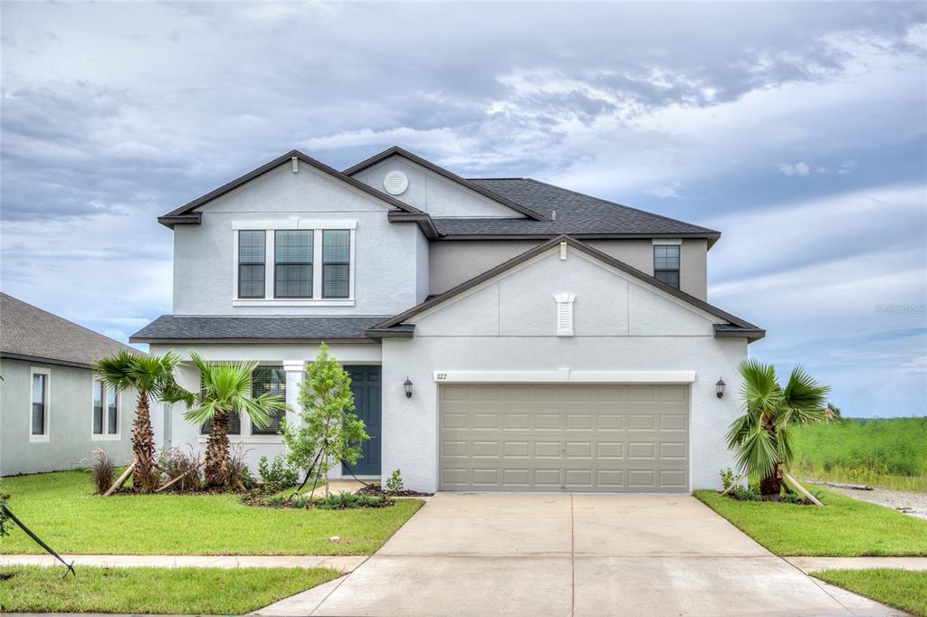 1172 Montgomery Bell Road Wesley Chapel, FL 33543 - Photo 1 of 47 a front view of a house with garden
