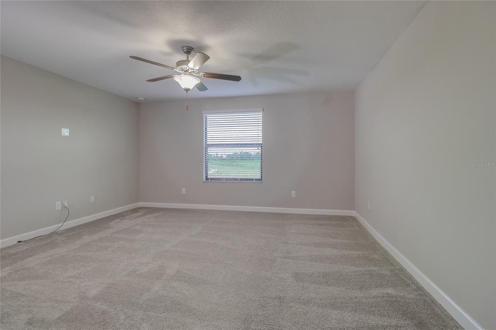 1172 Montgomery Bell Road Wesley Chapel, FL 33543 - Photo 21 of 47 an empty room with a window and a fan