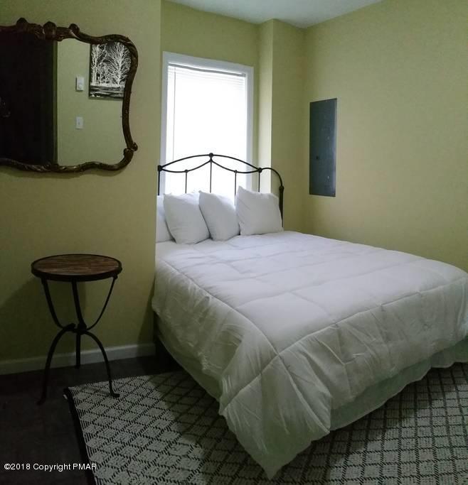 6145 Decker Road Bushkill, PA 18324 - Photo 17 of 32 a bedroom with a bed chair and a window