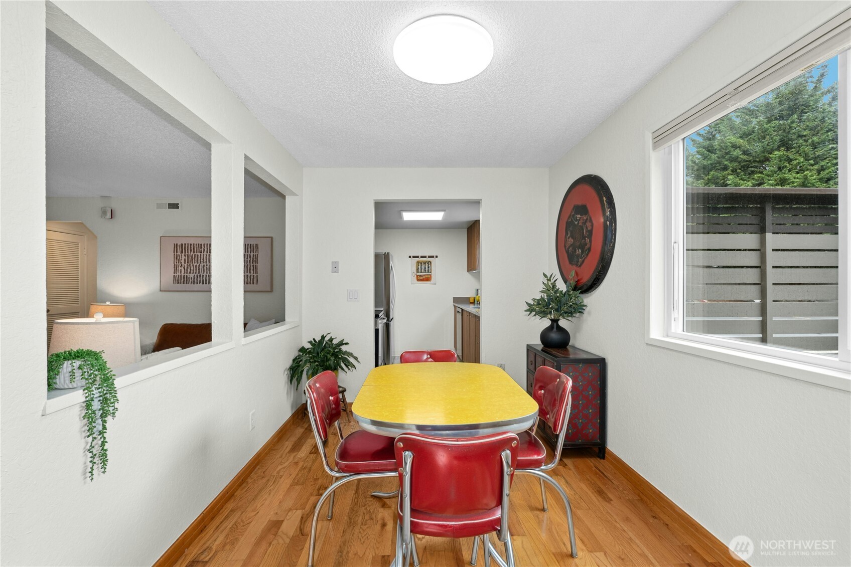 9523 Northeast 180th Street, Unit A102 Bothell, WA 98011 - Photo 8 of 29 a view of a dining room with furniture window and wooden floor