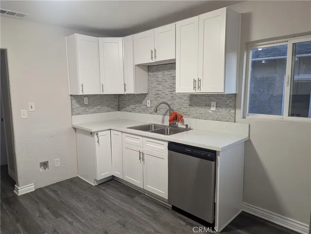a kitchen with a sink and cabinets