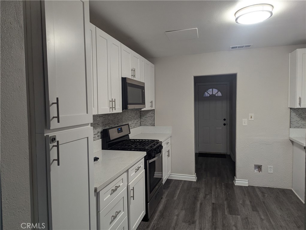 12001 Vivienda Avenue Grand Terrace, CA 92313 - Photo 4 of 7 a kitchen with a sink a microwave and cabinets