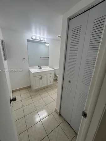 a bathroom with a sink a mirror and a toilet