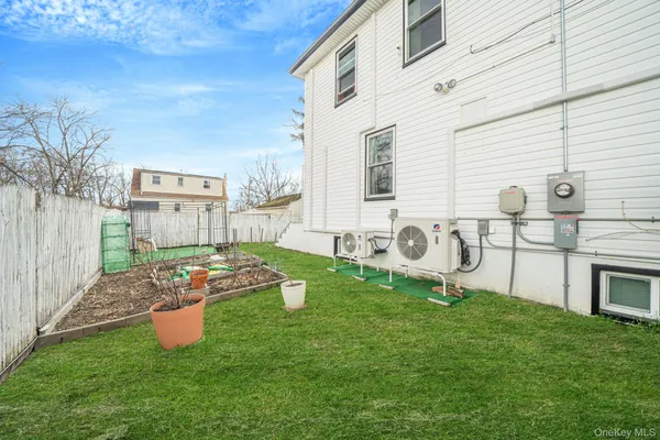 a backyard of a house with table and chairs
